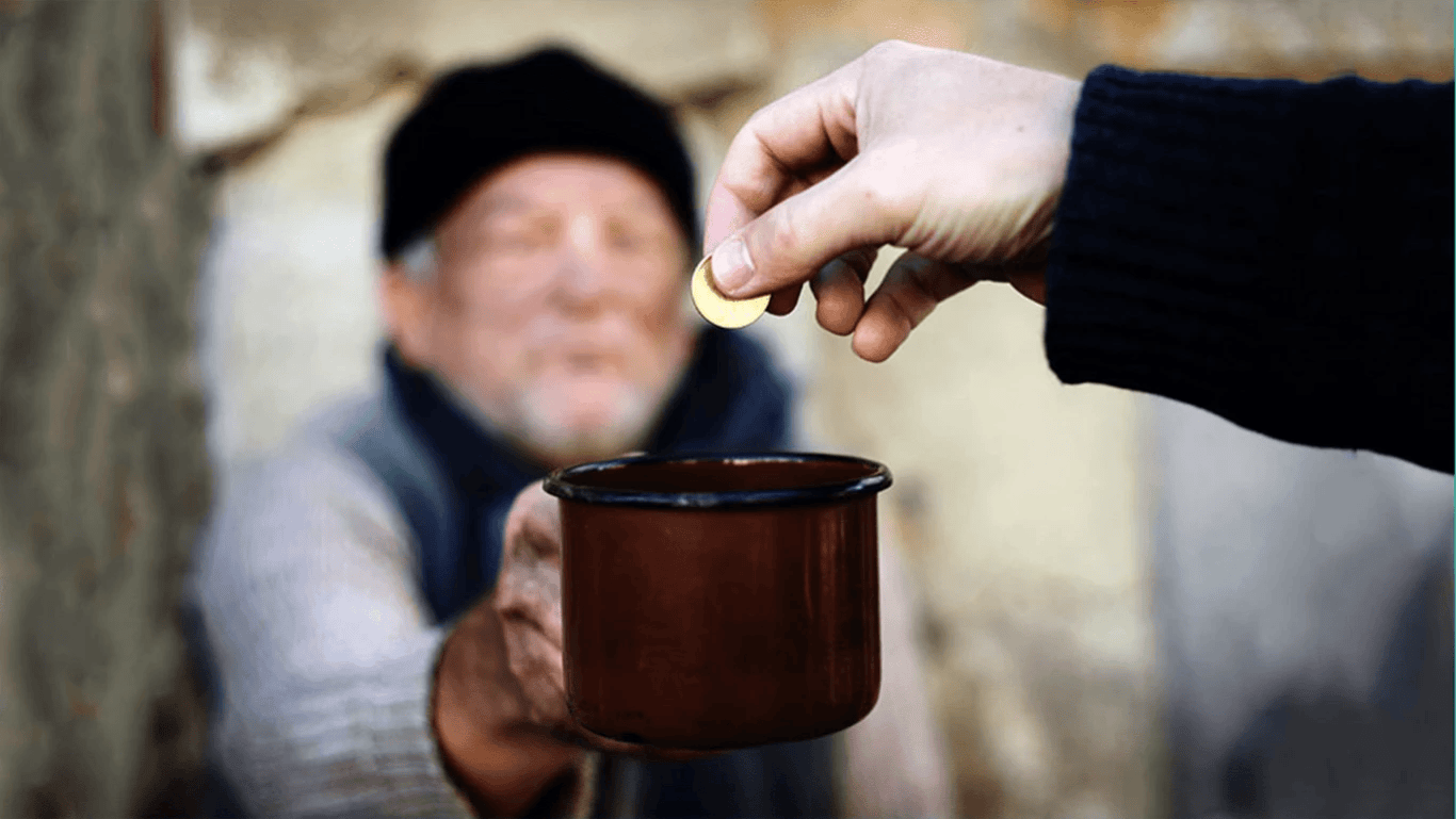 Muslim donor using a smartphone to give charity through the Feeling Blessed app with digital Zakat and Sadaqah tools