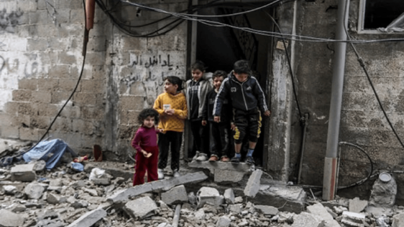 A family in Palestine receiving food and humanitarian aid from charity workers during an emergency relief effort