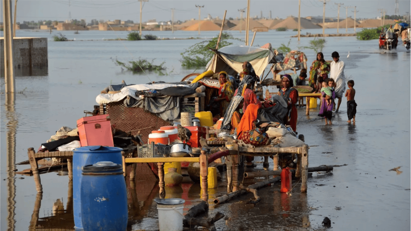 Flood affected families in Pakistan receiving food and emergency aid from relief workers